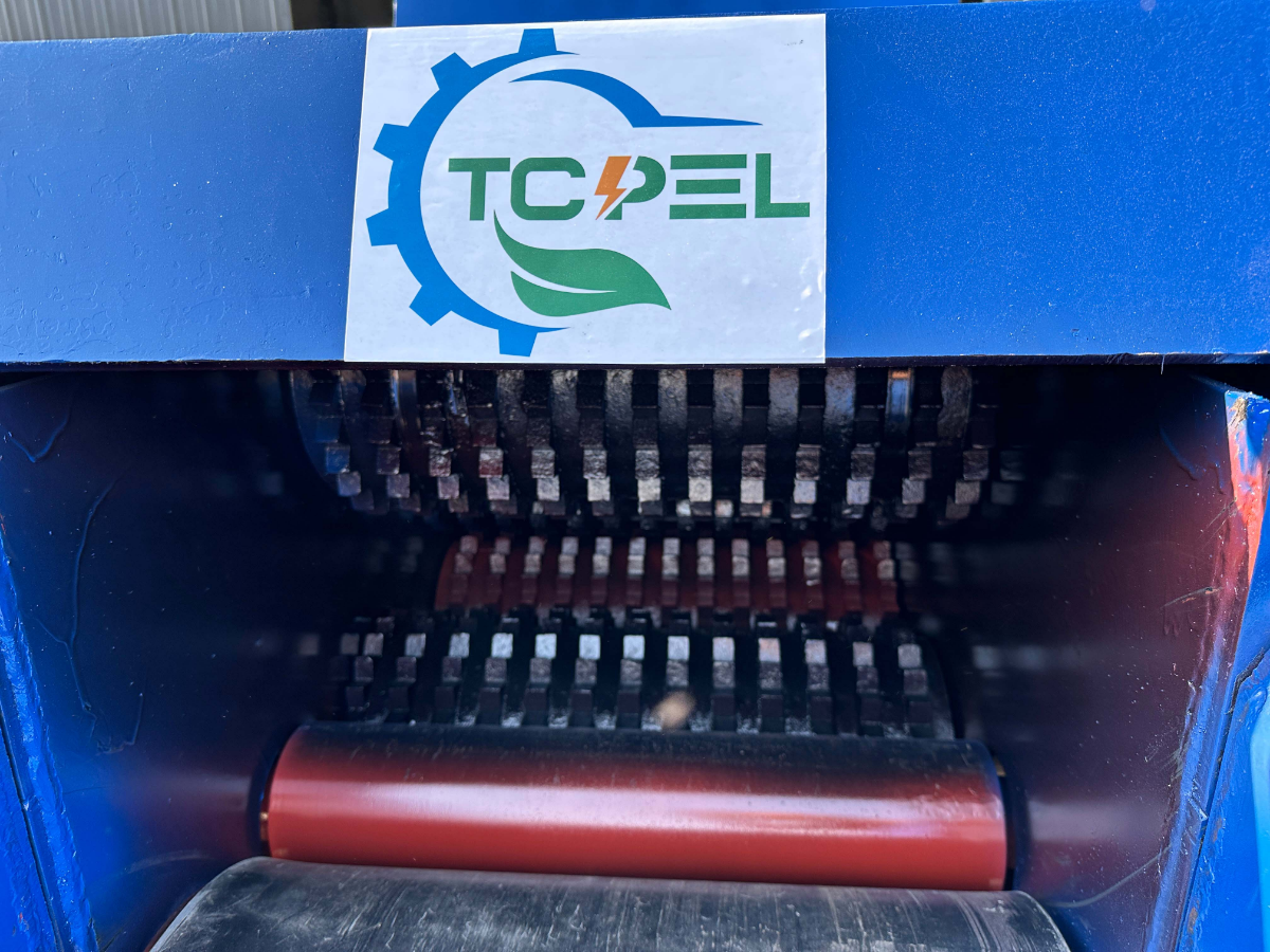 Disc chipper spins steel flywheel with knives around the edge